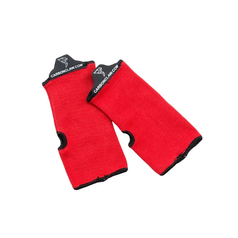 The Carbon Claw Aero AX-5 Inner Mitts, red with black trim and thumb holes, feature logo and website labels on the cuffs for reliable glove sweat protection. Displayed on a white background.