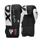 A pair of black and white RDX boxing gloves are shown, with one glove standing upright and the other resting on its side. The gloves feature bold branding and a secure wrist strap.
