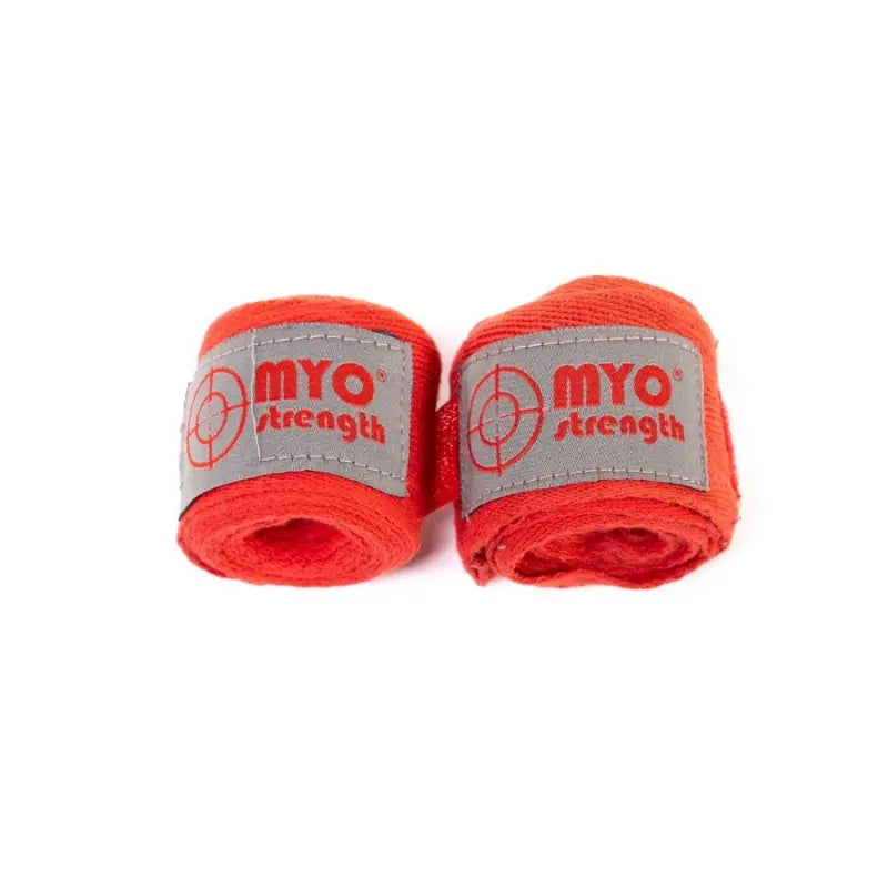 Two rolled MYO Strength Hand Wraps – 2.5m Cotton (Red) with gray labels featuring the red MYO Strength logo, placed side by side on a white background, provide excellent wrist and knuckle protection for boxing enthusiasts.