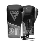 A pair of black and silver RDX - K1 Mark Pro Fight Boxing Gloves in Super Skin leather—one shows the logos and text, the other displays the laced back and palm.