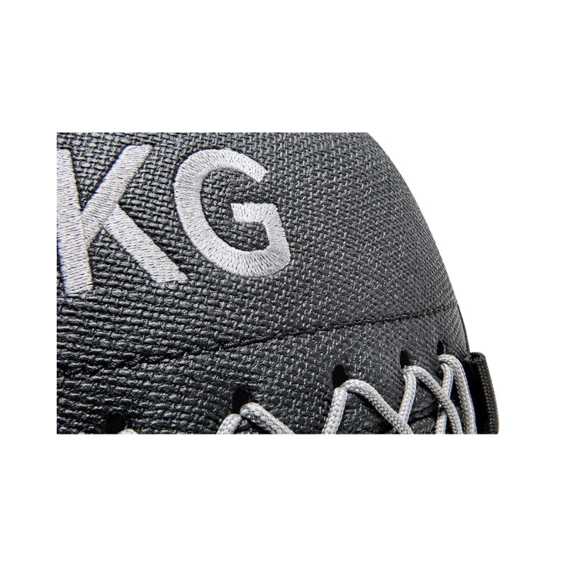 Close-up of a grey wall ball with 'KG' branding on a white background