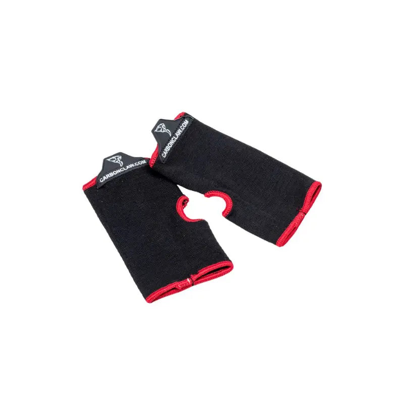The Carbon Claw Aero AX-5 Inner Mitts, red with black trim and thumb holes, feature logo and website labels on the cuffs for reliable glove sweat protection. Displayed on a white background.