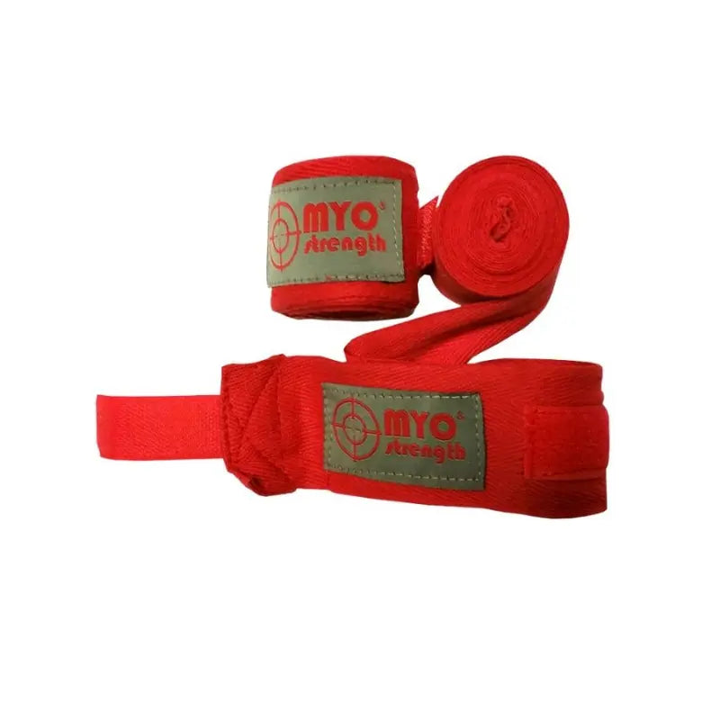Two rolled MYO Strength Hand Wraps – 2.5m Cotton (Red) with gray labels featuring the red MYO Strength logo, placed side by side on a white background, provide excellent wrist and knuckle protection for boxing enthusiasts.