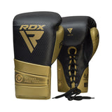A pair of black and gold RDX - K1 Mark Pro Fight Boxing Gloves with laces, made from Super Skin combat leather, featuring the RDX logo and Pro Training text on the wrist.