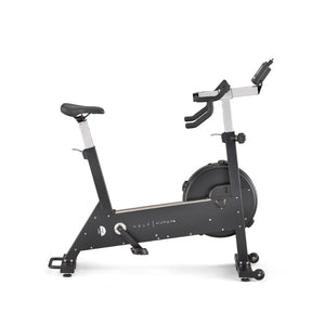 A black stationary exercise bike with an adjustable seat and handlebars, a water bottle holder, and a flywheel at the front, standing on a white background.