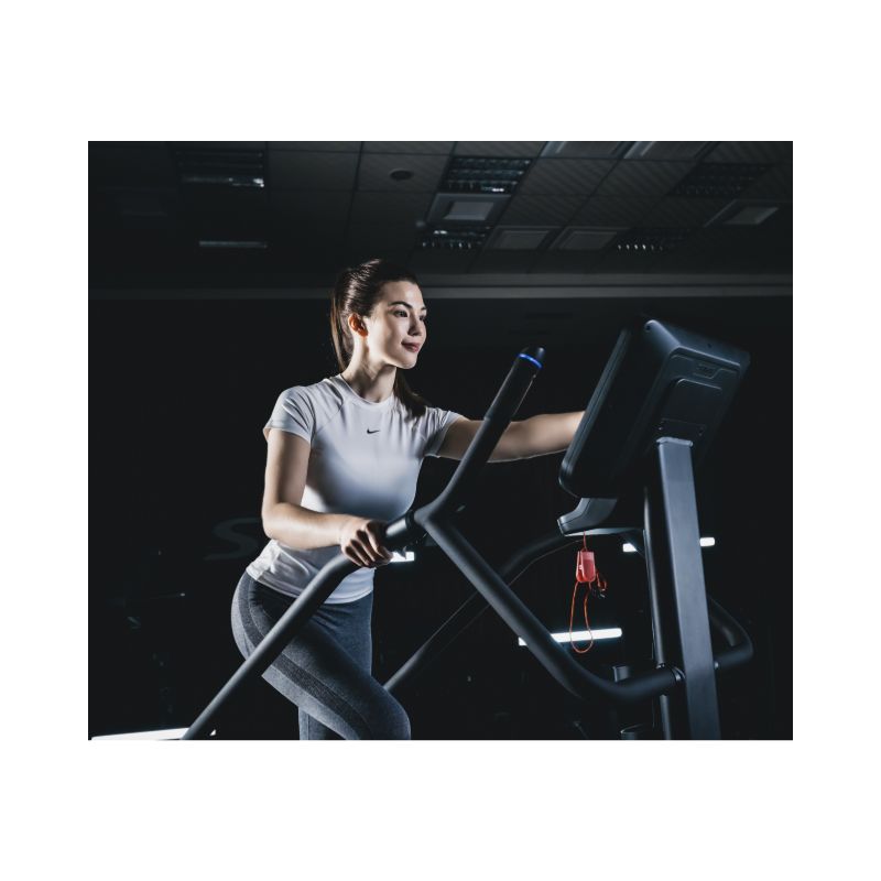 Woman exercising on a Stair Climber in a gym setting