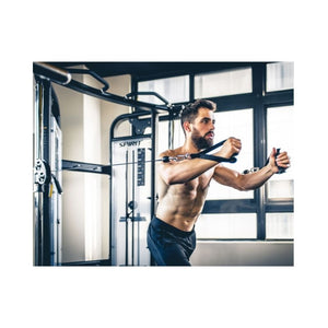 Man exercising with cable machine in a gym setting