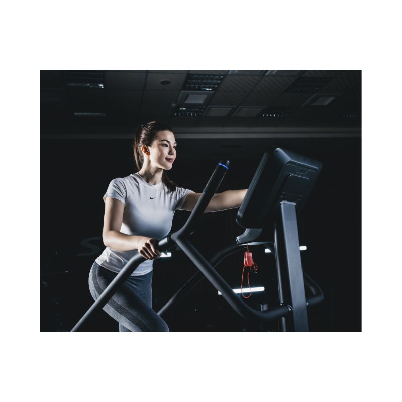 Woman exercising on a Stair Climber in a gym setting