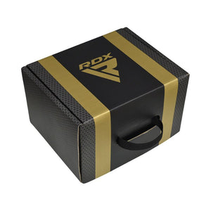 A black box with gold stripes and a gold "RDX" logo on the lid, featuring a textured pattern and a black handle on the front.