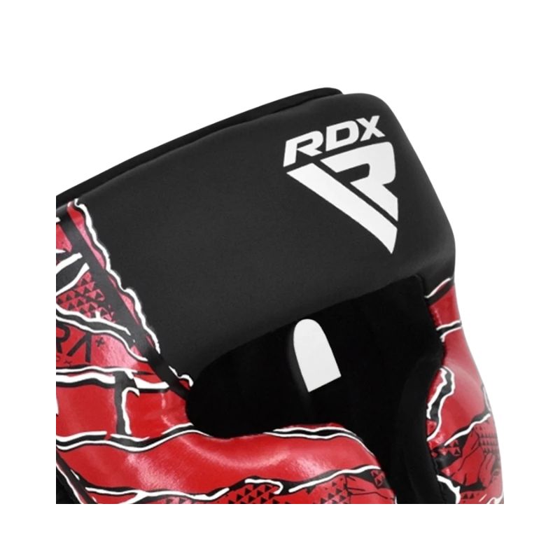 Close-up of an RDX boxing glove showing the black wrist strap with a white RDX logo and the red and black patterned glove body, on a white background.