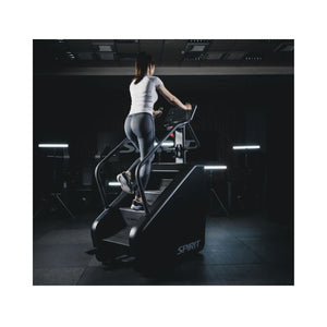 Person using a  Stair Climber machine in a gym setting