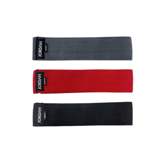 The JORDAN Fabric Resistance Band is a non-slip booty band for squats, lunges, and glute workouts. Shown in red with a black Jordan Medium label against a white background.