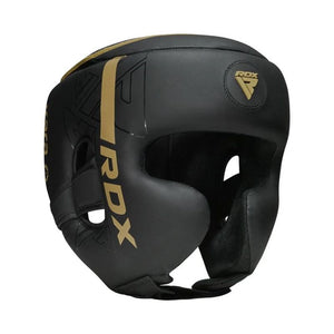 A black protective boxing headguard with gold accents, featuring the RDX logo and branding on the side and front, set against a plain white background.
