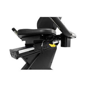 Close-up of a black exercise bike seat with a white background