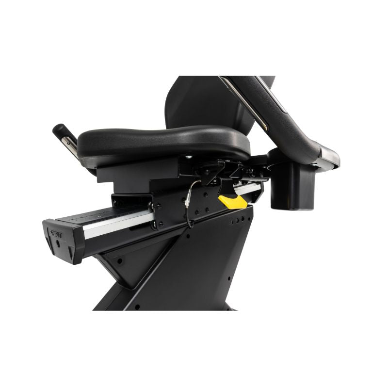 Close-up of a black exercise bike seat with a white background