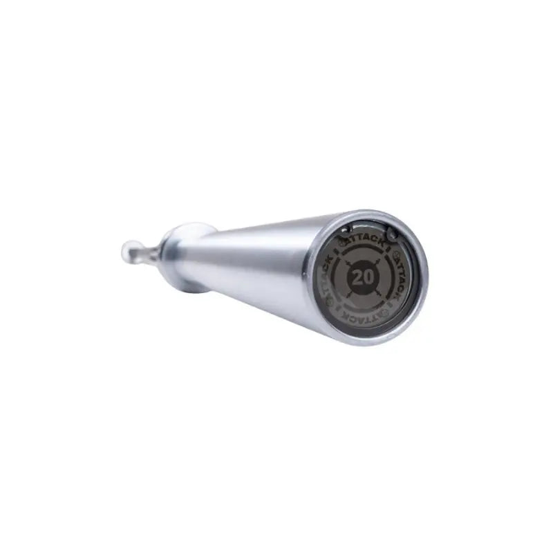A close-up of the Attack Fitness Olympic 7ft Bar’s end cap shows “20” and Tactical/Strike text around a crosshair. The Cerakote Black finish is visible as the bar, 1500lb tested, angles away on a white background.