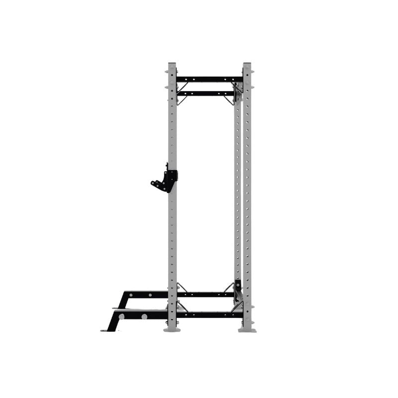 The Exigo X70 Half Rack by Exigo is a metal power rack with a pull-up bar and adjustable attachments, designed for strength training and weightlifting in commercial gyms, shown on a plain white background.