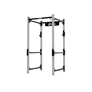 The Exigo X70 Compact Power Rack by Exigo is a freestanding silver rack with black support bars, featuring adjustable safety bars, multiple height settings, and a pull-up bar—ideal home gym equipment for weightlifting.