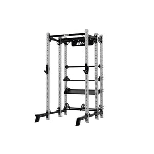 The Exigo X70 Half Rack by Exigo is a metal power rack with adjustable safety bars and pull-up handles, ideal for strength training and weightlifting in commercial gyms. Displayed on a white background.