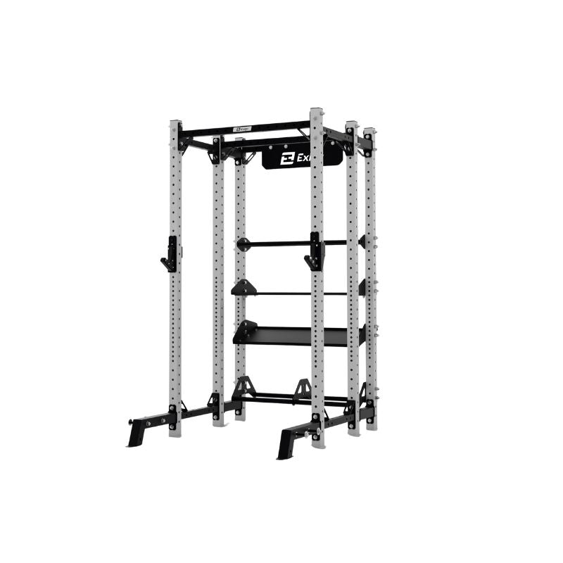 The Exigo X70 Half Rack by Exigo is a metal power rack with adjustable safety bars and pull-up handles, ideal for strength training and weightlifting in commercial gyms. Displayed on a white background.