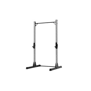 The Exigo X70 Quarter Rack by Exigo is a gray metal rack with adjustable black supports and a pull-up bar, designed for strength training and weightlifting in home gyms. Isolated on a white background.
