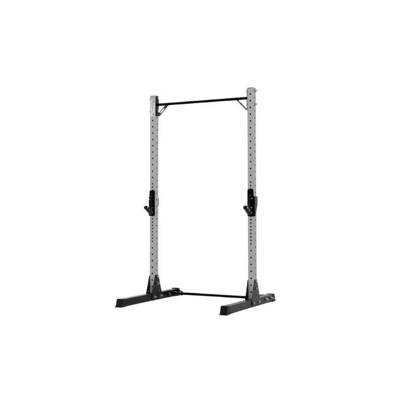 The Exigo X70 Quarter Rack by Exigo is a gray metal rack with adjustable black supports and a pull-up bar, designed for strength training and weightlifting in home gyms. Isolated on a white background.