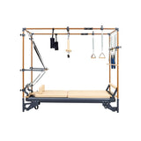 The HEGREN TALMA 62CR Cadillac Reformer – Integrated Reformer & Trapeze System by Hegren features a beige cushioned bed, sturdy wood/metal frame, adjustable springs, straps, and handles—ideal for versatile Pilates exercise routines.