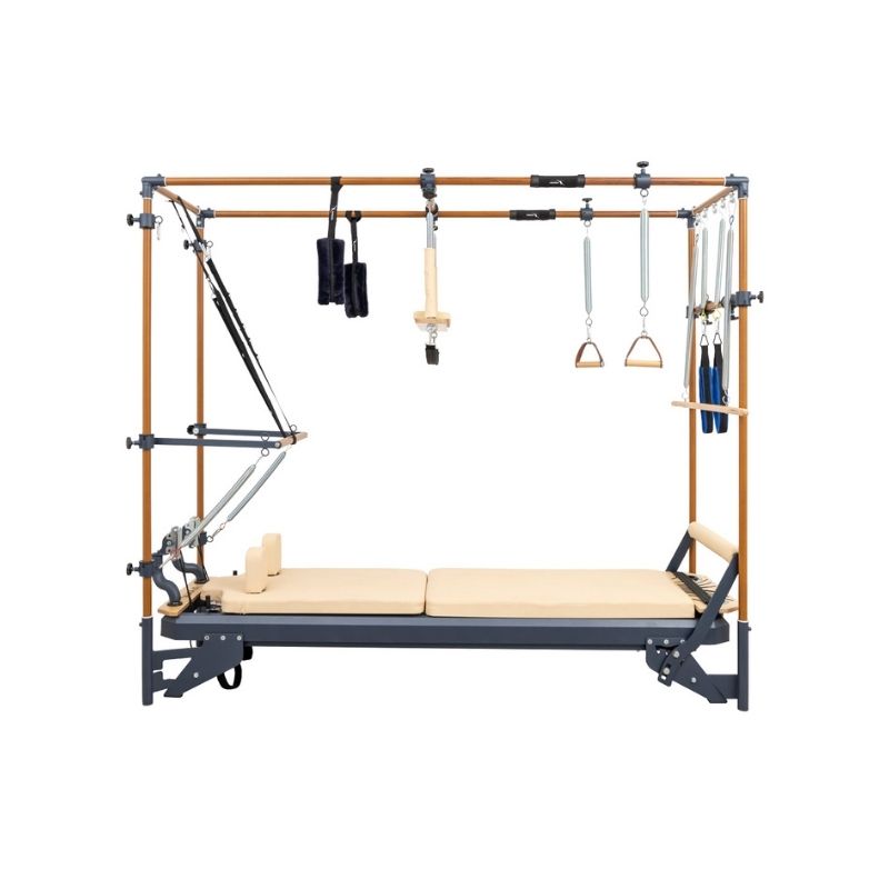 The HEGREN TALMA 62CR Cadillac Reformer – Integrated Reformer & Trapeze System by Hegren features a beige cushioned bed, sturdy wood/metal frame, adjustable springs, straps, and handles—ideal for versatile Pilates exercise routines.