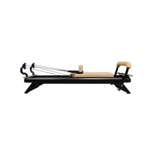 The Hegren TALMA 62 Pilates Reformer features a studio-grade steel frame in black, beige padding, hand straps, cushioned carriage, and adjustable foot bar—ideal for home or studio. Fast UK delivery available.