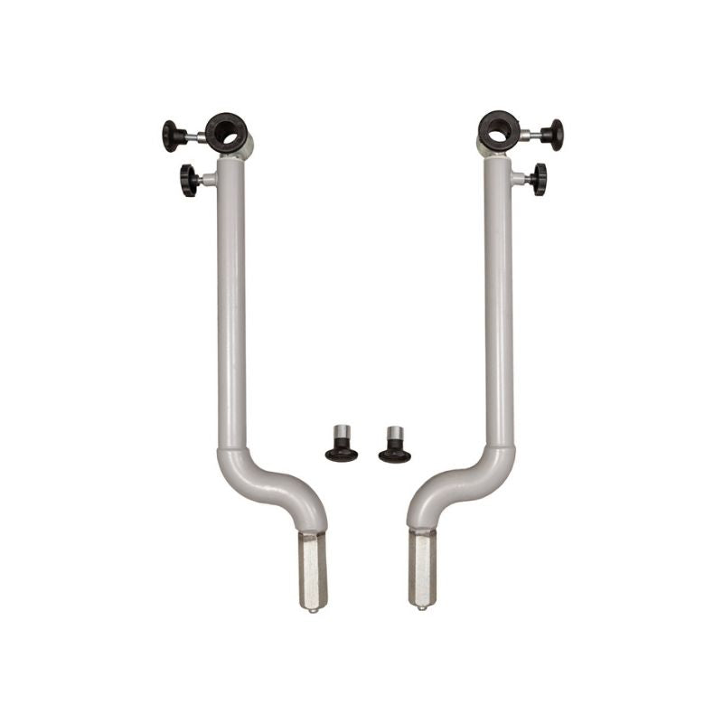 Two silver HEGREN Stability Bars by Hegren, with black adjustment knobs, bent lower sections, and cylindrical top attachments, stand side by side. Two small round black components are placed between these adjustable Pilates support bars.