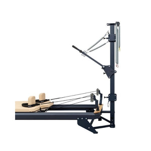The Hegren TALMA 62CT Convertible Pilates Tower offers studio-grade performance with adjustable pulleys, ropes, handles, and a padded wooden platform and headrests for versatile resistance training and exercises.
