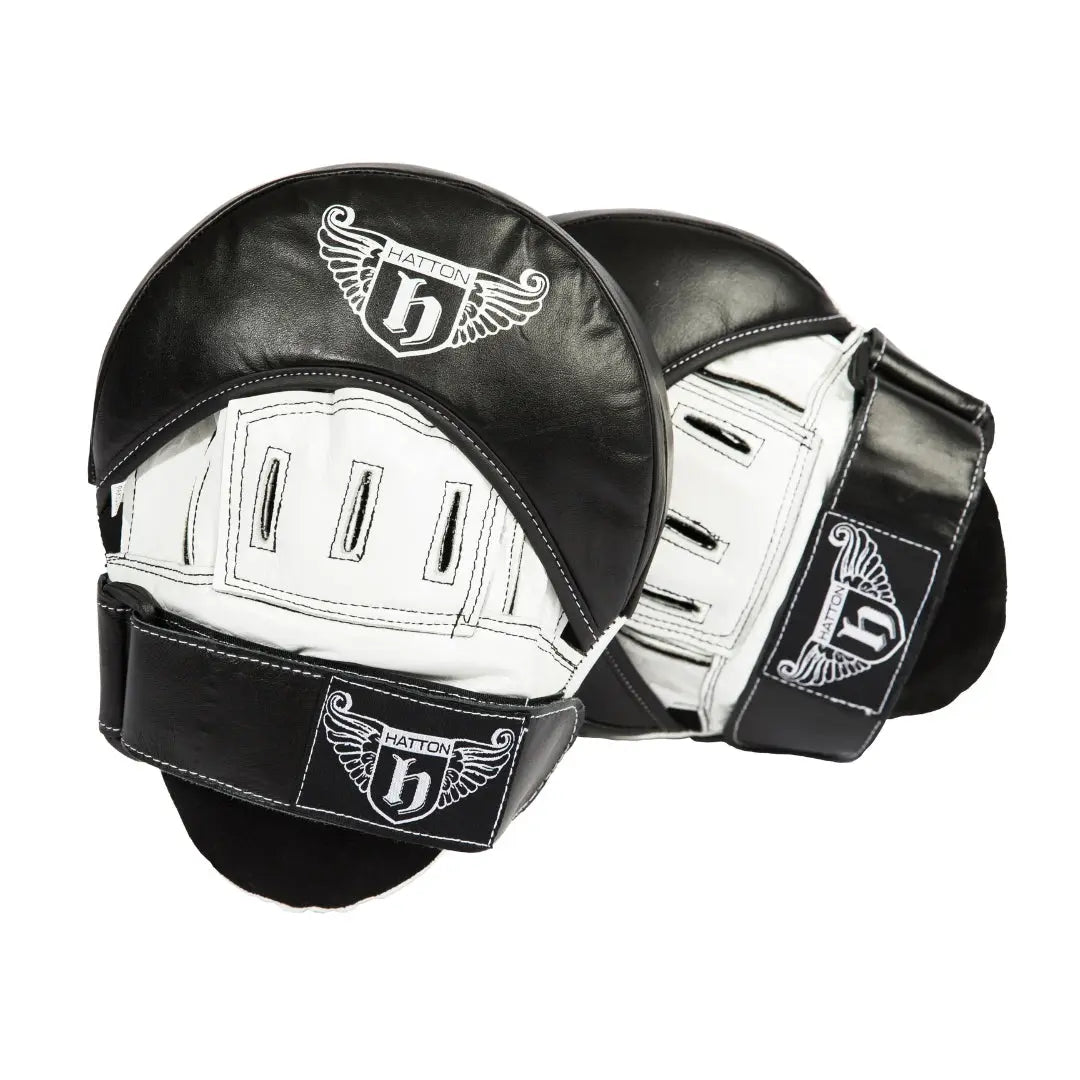The HATTON BOXING AirPro Hook & Jab Pads by Hatton are black and white with a winged H logo. They feature a curved design, Air Flow Technology for ventilation, shock-absorbent padding, and a secure strap for added comfort during training sessions.