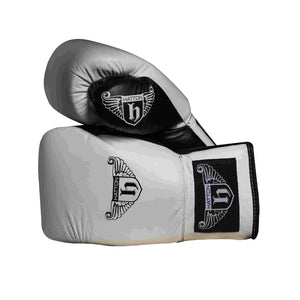The Hatton Boxing Lace Up Gloves from Hatton, crafted in white and black leather, feature intricate shield and wings logo designs on the wrist. These gloves are perfect for sparring, displayed to show both front and thumb sides.