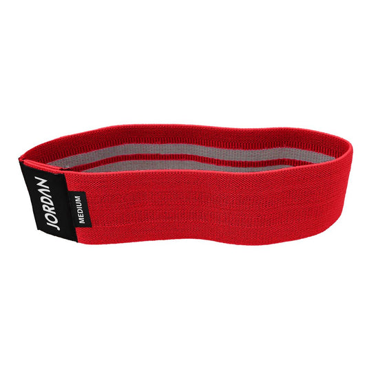 The JORDAN Fabric Resistance Band is red with Jordan and Medium on a black label, offering a smooth texture and moderate elasticity. Its durable design makes it perfect for fitness and strength training, providing versatile workout options.
