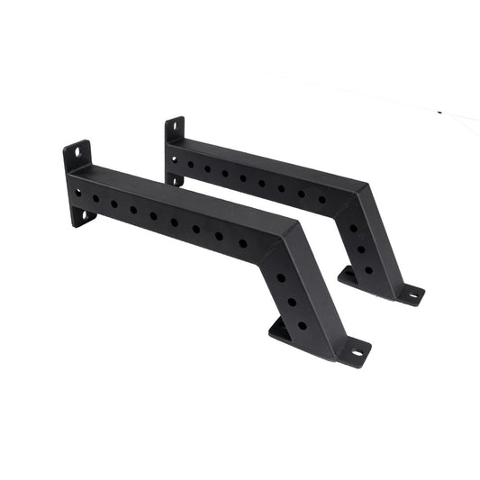 The Jordan Helix Fixed Power Rack Foot Attachments (pair) are black metal wall brackets with a Z-shape and multiple circular holes for mounting. These commercial-quality components are perfect for supporting shelves or racks, ensuring sturdy attachment in gym settings.