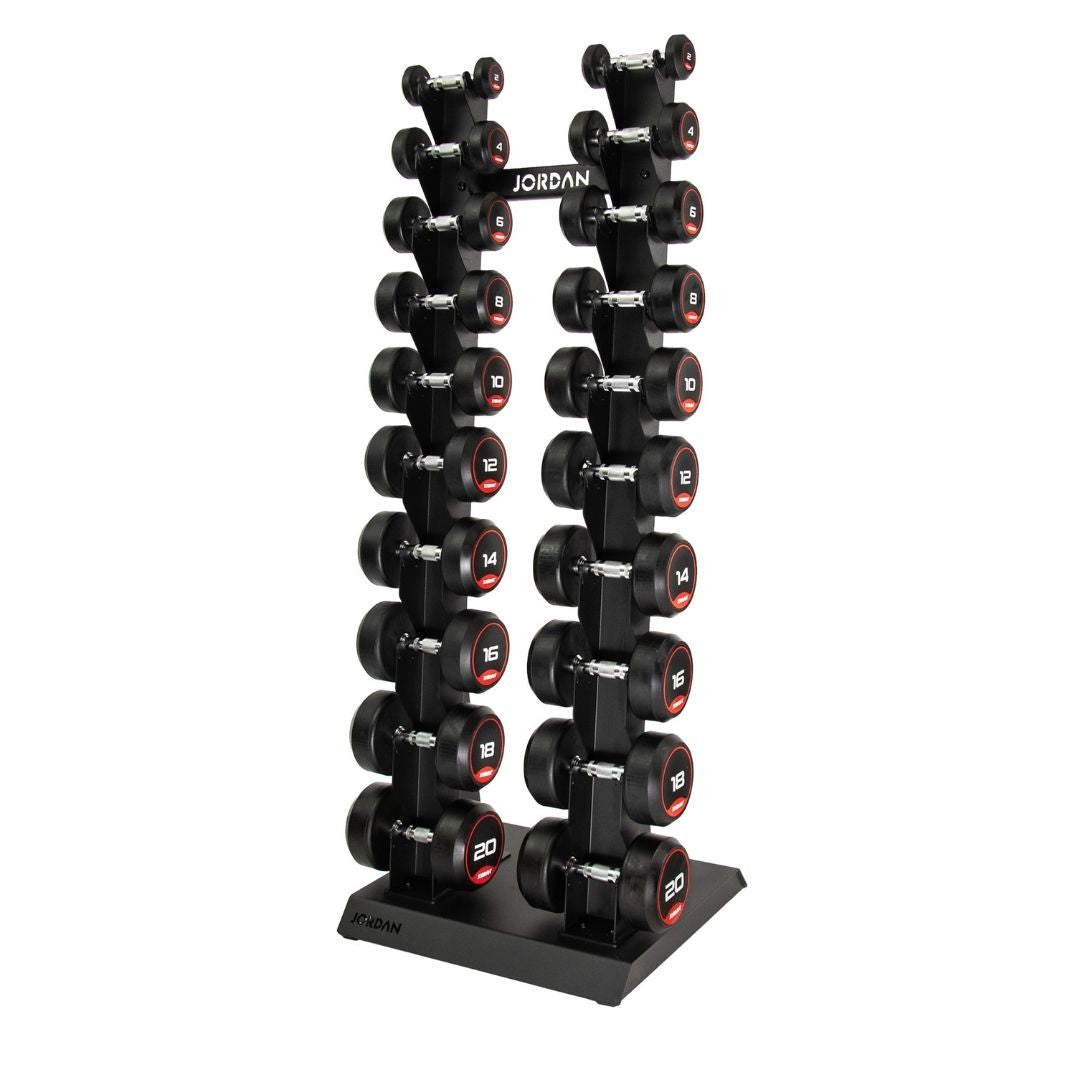 A home gym vertical rack holds a JORDAN Dumbbell Set with black dumbbells and red accents, ranging from 2kg to 20kg, ideal for strength training. The sleek rack prominently displays the Jordan brand name.
