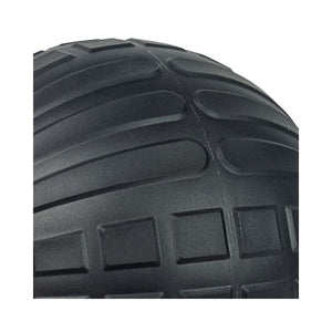 Close-up of a black JORDAN High-Performance Slam Ball by Jordan, highlighting its detailed tread with curved and rectangular grooves—ideal for strength training or high-intensity workouts.