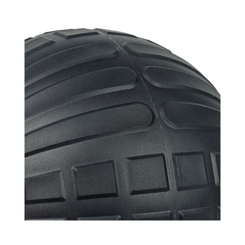 Close-up of a black JORDAN High-Performance Slam Ball by Jordan, highlighting its detailed tread with curved and rectangular grooves—ideal for strength training or high-intensity workouts.