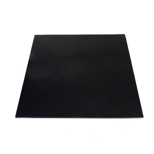 Close-up of two MYO Strength Rubber Black Tiles (1000mm x 1000mm x 20mm) stacked at an angle, showing their textured surface and smooth edges—ideal as durable gym flooring or for impact protection. Brand: MYO Strength.