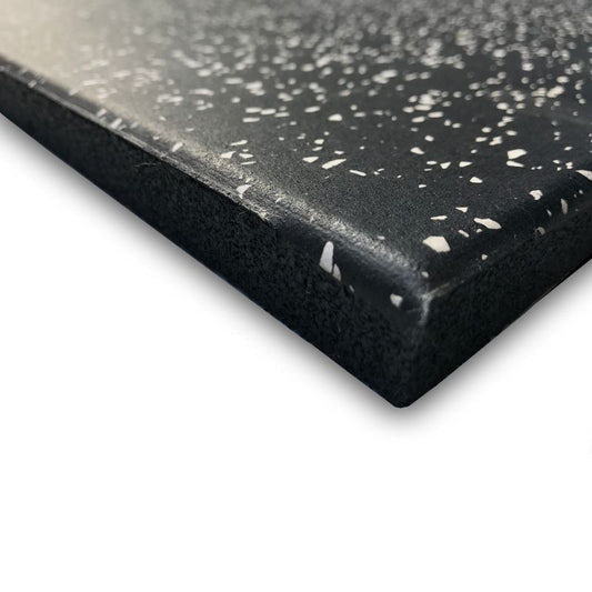Close-up of the MYO Strength - Rubber Black Tile with White Speckled Surface, showing its textured, shock-absorbing design and beveled edge. The MYO Strength mats non-slip surface and thickness are highlighted against a white background.