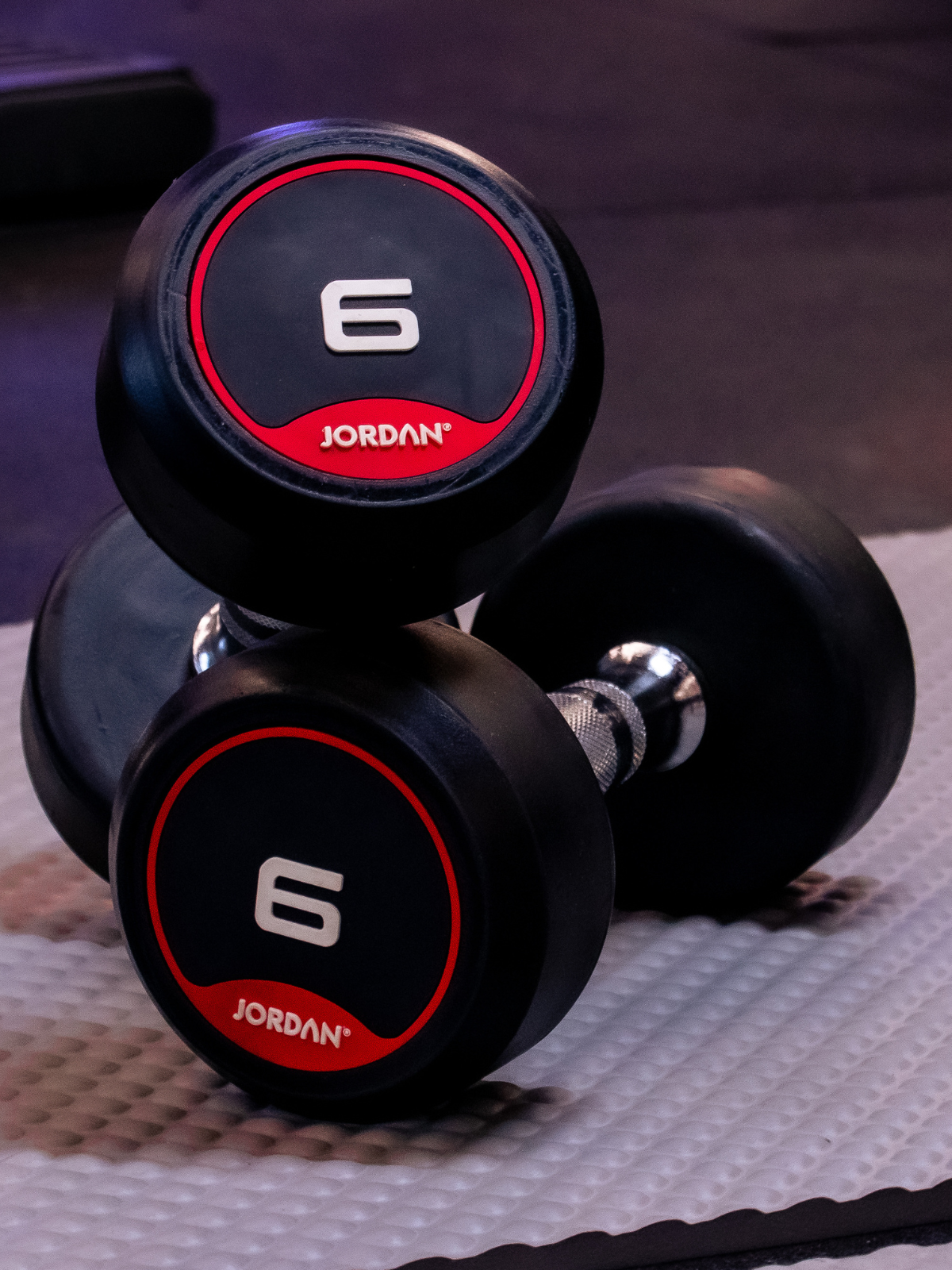 Pair of Jordan brand dumbbells with '6' marking on a textured surface