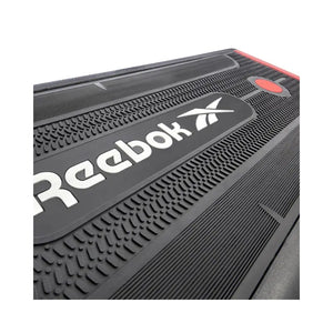 The Jordan Reebok Deck – Adjustable Fitness Platform for Home and Studio Workouts is shown in black and red with branding, set in a raised incline position on a white background, ideal for versatile cardio and strength training.