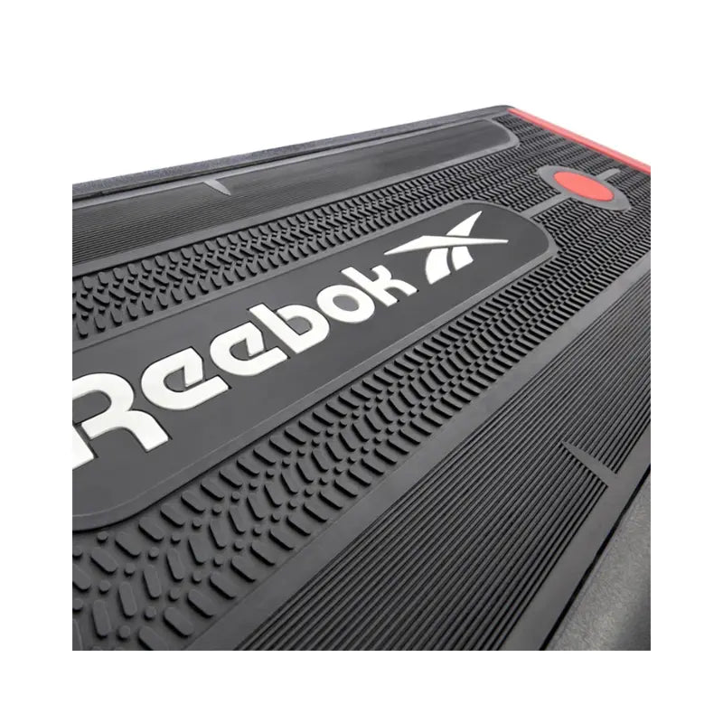 The Jordan Reebok Deck – Adjustable Fitness Platform for Home and Studio Workouts is shown in black and red with branding, set in a raised incline position on a white background, ideal for versatile cardio and strength training.