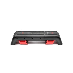 The Jordan Reebok Deck – Adjustable Fitness Platform for Home and Studio Workouts is shown in black and red with branding, set in a raised incline position on a white background, ideal for versatile cardio and strength training.