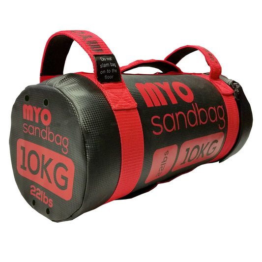 A red and black MYO Strength Sandbag with two handles, labeled 10KG/22lbs. This cylindrical MYO Strength product is built for functional fitness and strength training, ensuring durability and versatile performance.