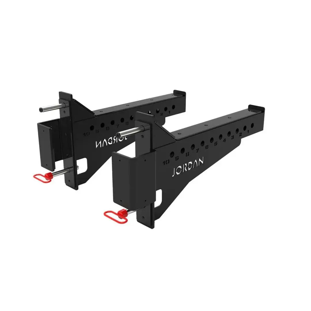 Positioned in parallel, the JORDAN J75 Safety Sport Arms Attachment (pair) features two black metal brackets with multiple holes, red wires, and an angled rectangular base. The Jordan brand name is visible in white, ensuring reliability for heavy lifting in strength training setups.