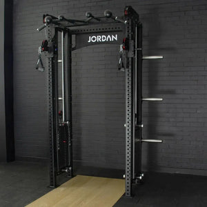 The JORDAN -J75 Cable Rack in black is a versatile gym power rack with barbells and weight plates on both sides. It features storage for weights and equipment, making it ideal for strength training exercises. The top arch is labeled Jordan.