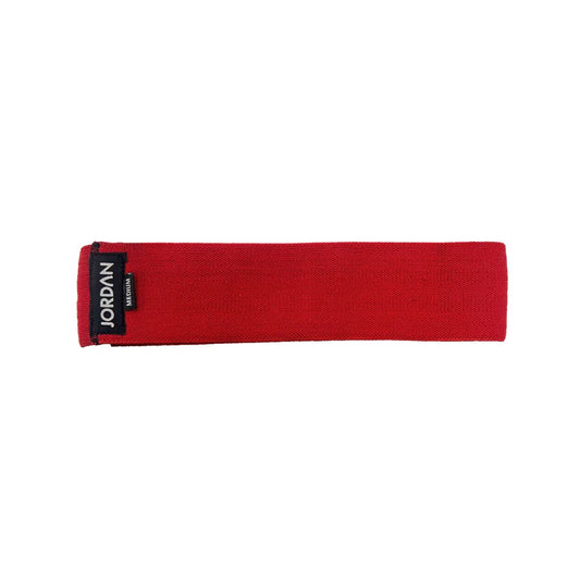 The JORDAN Fabric Resistance Band is red with Jordan and Medium on a black label, offering a smooth texture and moderate elasticity. Its durable design makes it perfect for fitness and strength training, providing versatile workout options.