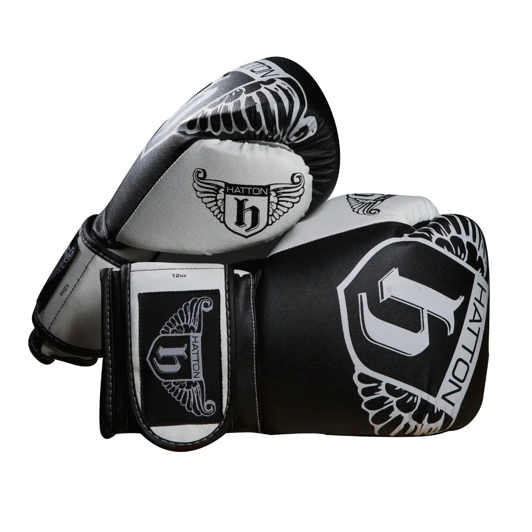 The sleek HATTON BOXING Boxing Gloves PU in black and white, featuring the Hatton brand and a winged logo, are shown overlapping against a white background.