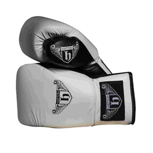 The Hatton Boxing Lace Up Gloves from Hatton, crafted in white and black leather, feature intricate shield and wings logo designs on the wrist. These gloves are perfect for sparring, displayed to show both front and thumb sides.